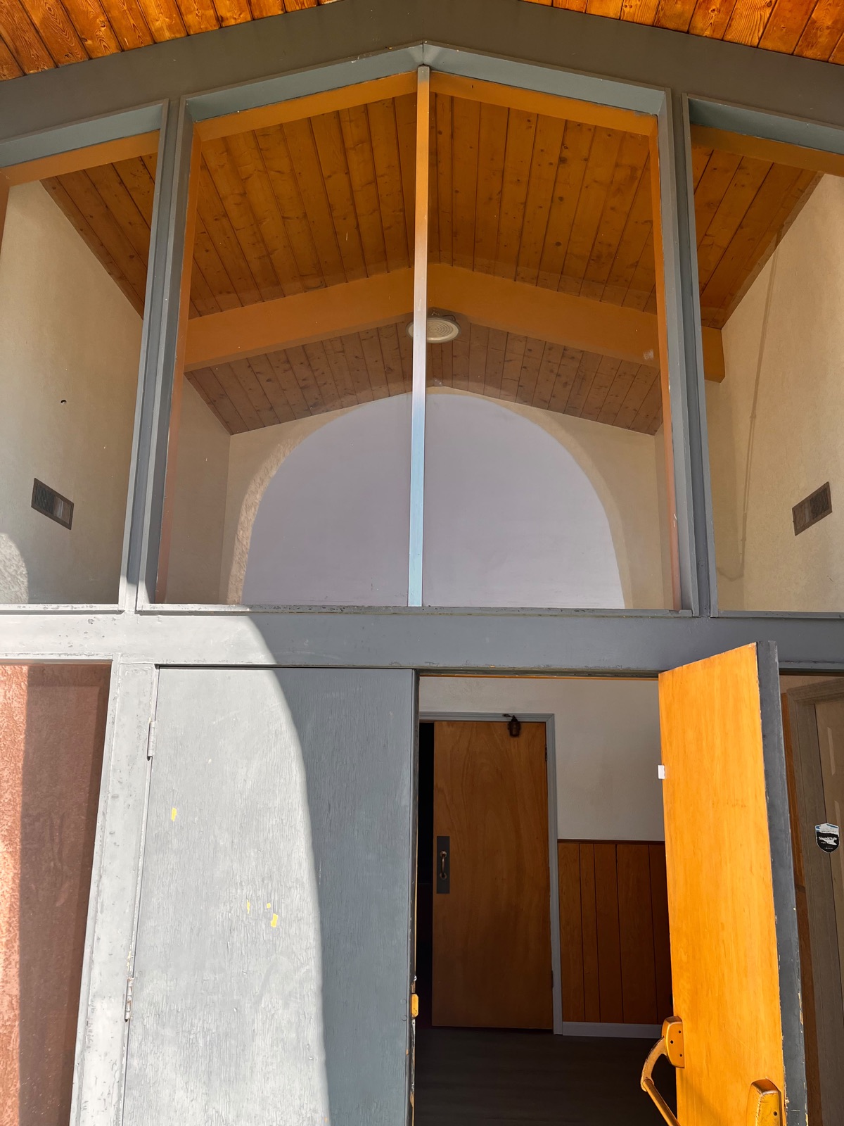 The open front doors of the church
